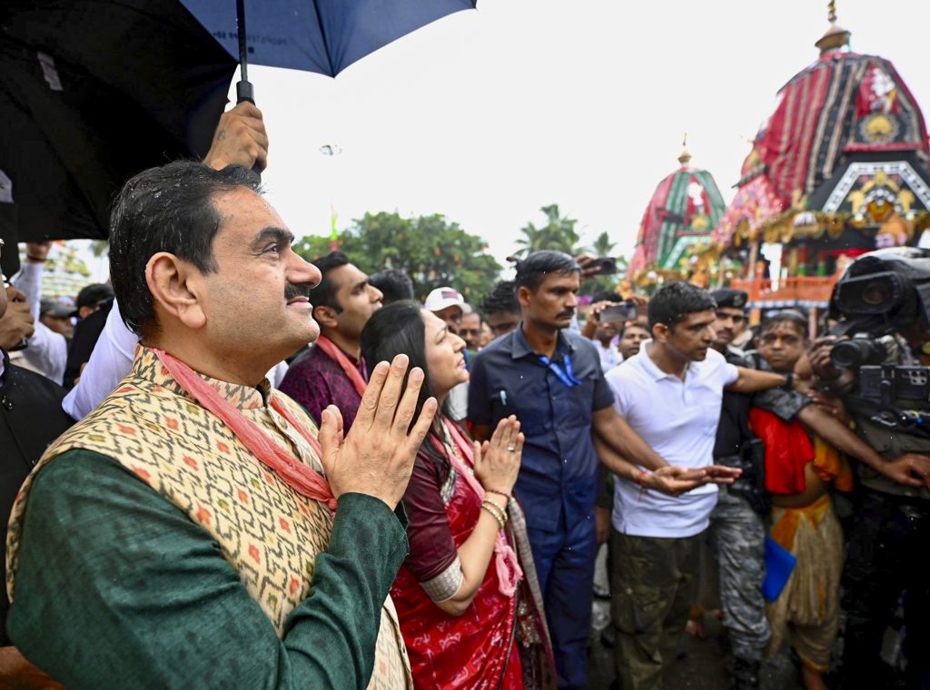 In this image posted by @gautam_adani via X on June 28, 2025, Adani Group Chairman Gautam Adani offers prayers with wife Priti and son Karan during the Rath Yatra festival near Gundicha Temple, in Puri, Odisha. Photo: @gautam_adani on X via PTI.