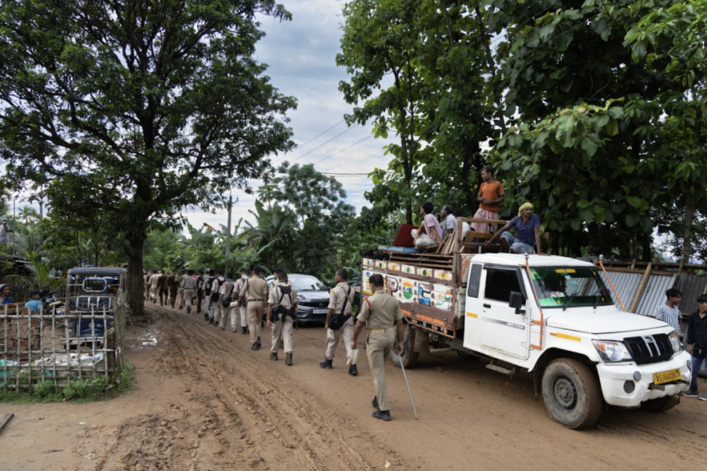 Amid the deployment of police personnel, residents vacate their homes in Shantoshpur village as part of the eviction drive in Dhubri, Assam, on July 5. Photo: Kazi Sharowar Hussain