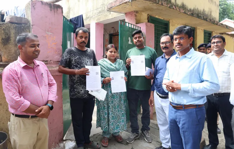 Patna District Magistrate Thiyagarajan S M talks to voters holding the forms they are required to submit to the Electoral Commission to confirm their right to vote, in Patna, Bihar, on June 29, 2025