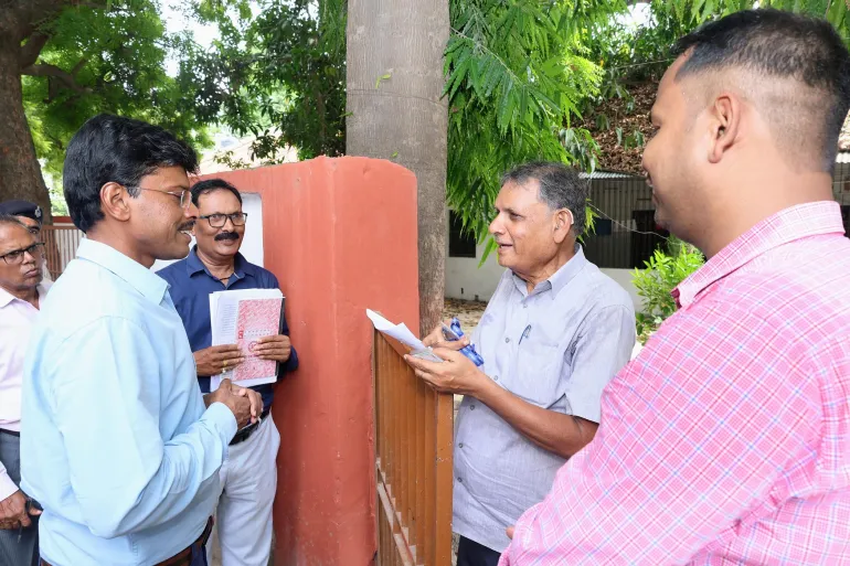Patna District Magistrate Thiyagarajan S M talks to local people during the distribution of ‘enumeration forms’, which voters must submit to the Electoral Commission to confirm their right to vote, in Patna, Bihar on June 29, 2025