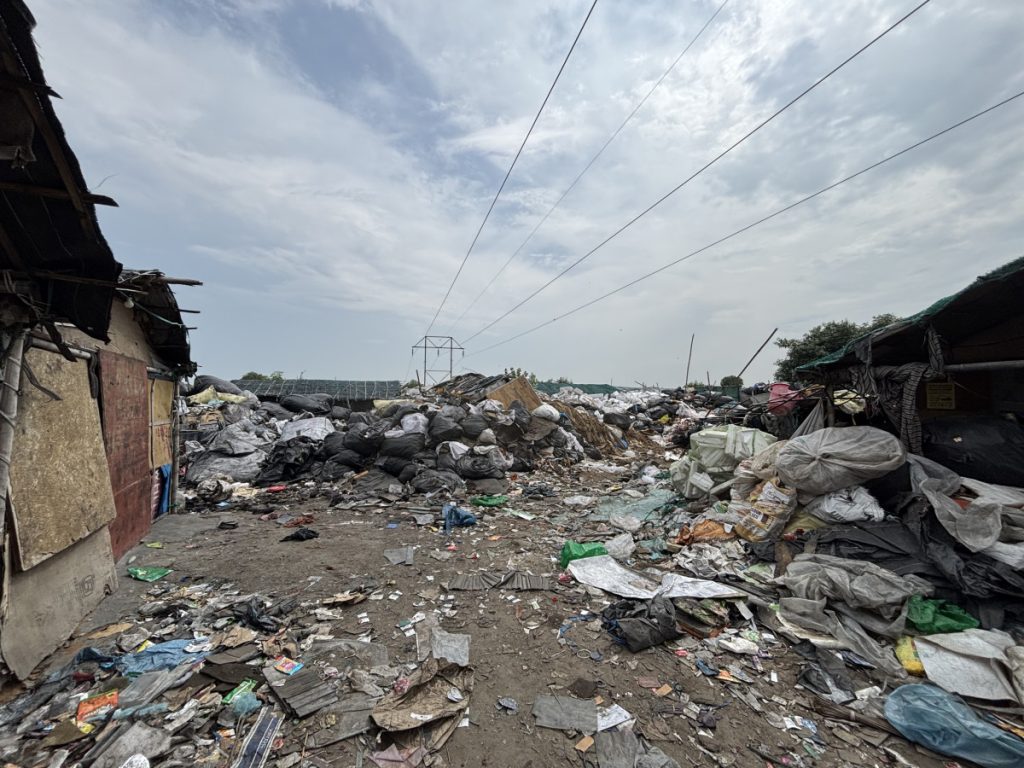 Residents live among piles of garbage scattered across the neighbourhood. 