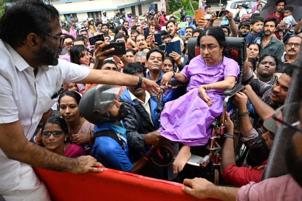 A woman is helped up during Achuthanandan’s final journey.