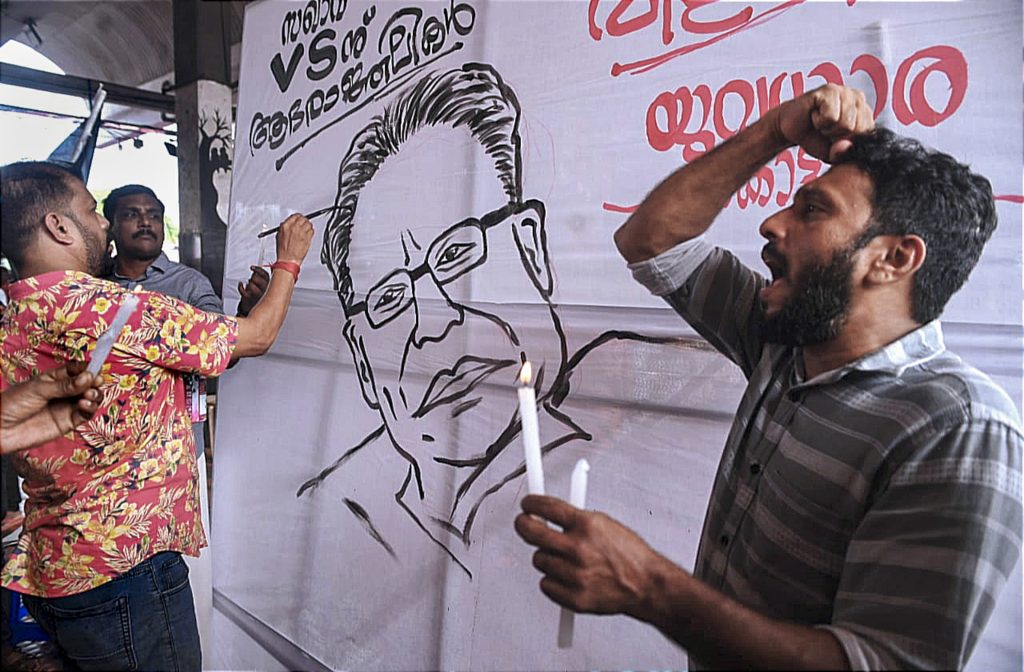People light candles as they pay tribute to Achuthanandan at the new bust stand in Kozhikode on July 22, 2025.