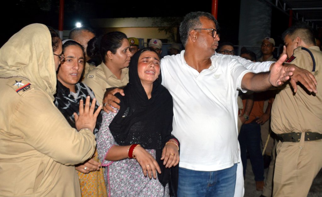 Bereaved family members of Parvez mourn outside the mortuary of a hospital, in Jammu, Thursday, July 24, 2025.