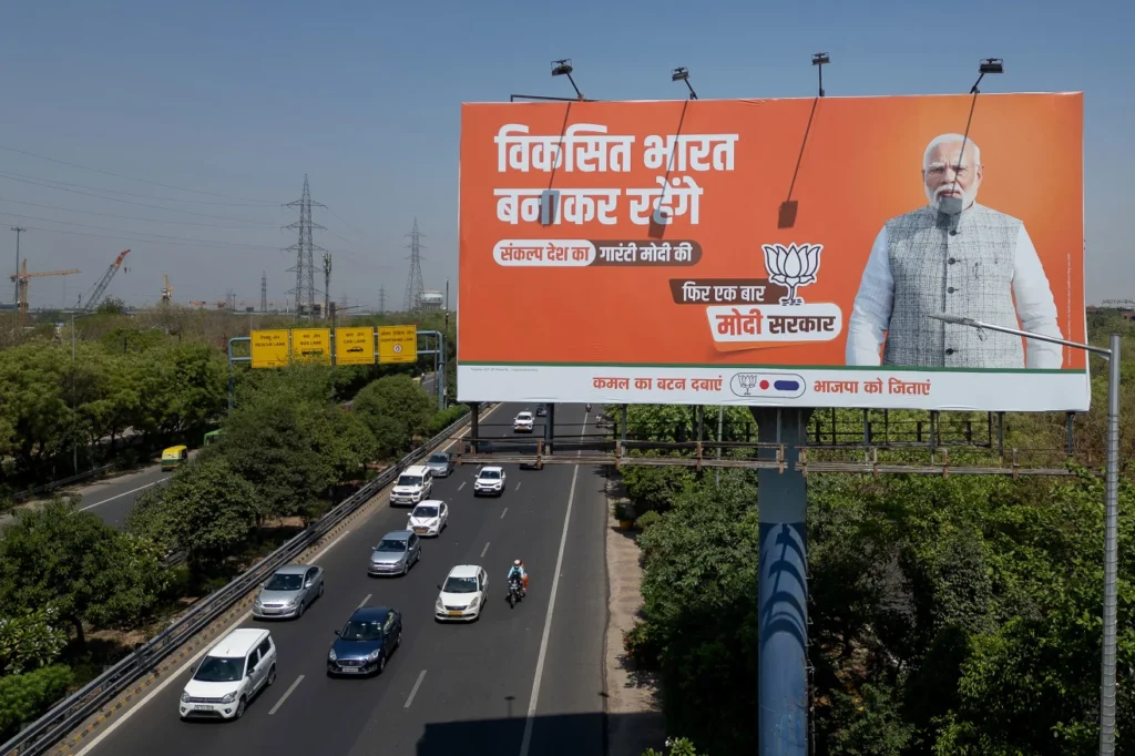 Prime Minister Narendra Modi appears on a Hindi-language billboard advertising the BJP in Noida, Uttar Pradesh, India, in April 2024.