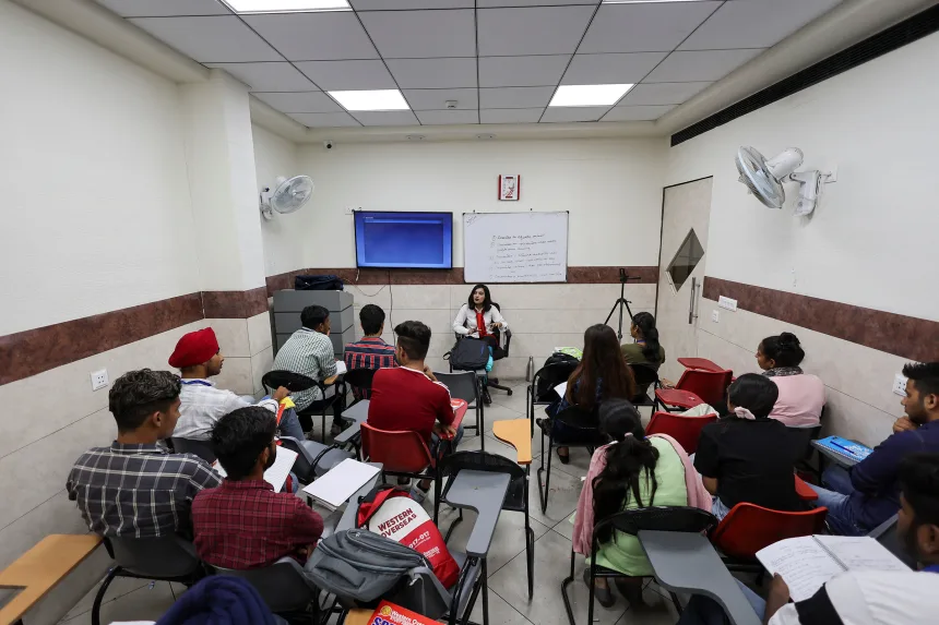 Students attend an International English Language Testing System class in Ambala, Haryana, India, in August 2022.