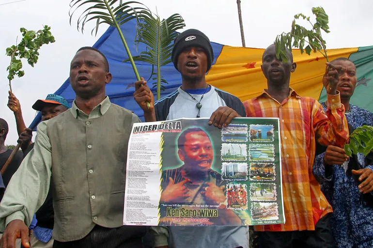 Protesters march to commemorate the 10th anniversary of the execution of Ken Saro-Wiwa in Port Harcourt, Nigeria, the city where he was put to death