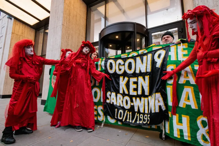 The Red Rebel Brigade, a performance activist arts group created as a response to the global environmental crisis, takes part in a protest outside the Shell Centre in London to remember the Ogoni Nine on the 29th anniversary of their executions