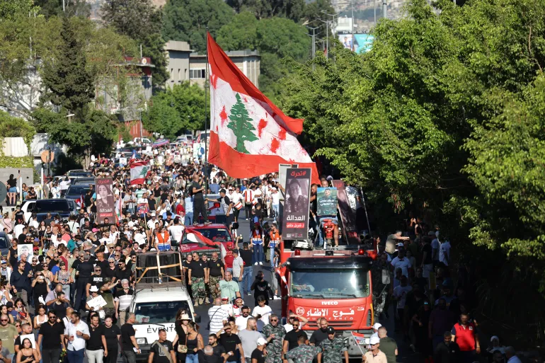 Protesters lift placards depicting the victims of the 2020 Beirut port blast during a march near the Lebanese capital’s harbour on August 4, 2023, marking the third anniversary of the deadly explosion