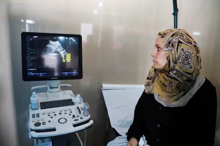 Fatima Arafa, a pregnant and displaced Palestinian woman, has a consultation with a doctor at Al Helou Hospital in Gaza City, on July 10, 2025