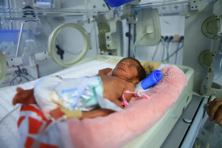 A premature baby lies in an incubator at Al Helou Hospital, where doctors say a shortage of specialised formula milk is threatening the lives of newborns, in Gaza City, June 25, 2025