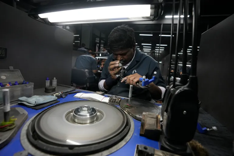 A worker checks the polishing of a lab-grown diamond  in Surat, India, Monday, February 5, 2024