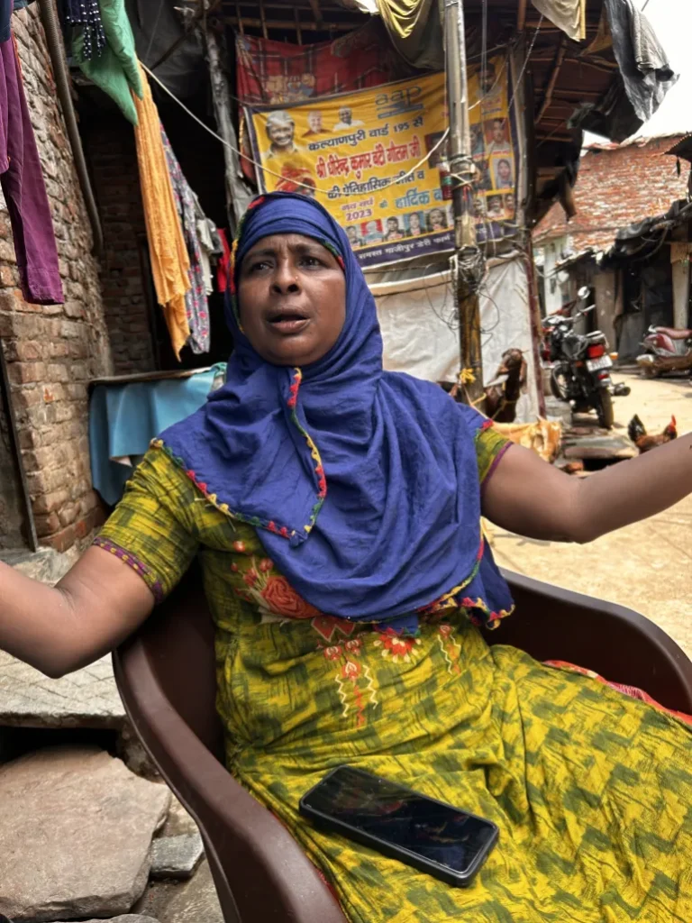 Sofia Begum, 38, in the slum settlement she lives in beside the Ghazipur landfill site in New Delhi. Her eye was infected by medical waste last year and it swells painfully in sunlight