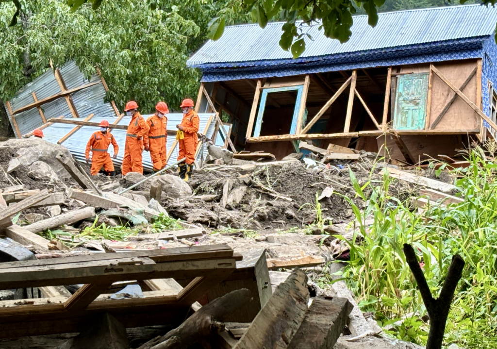 A group of state and central disaster response officials at the site of the tragedy in Chisoti village.
