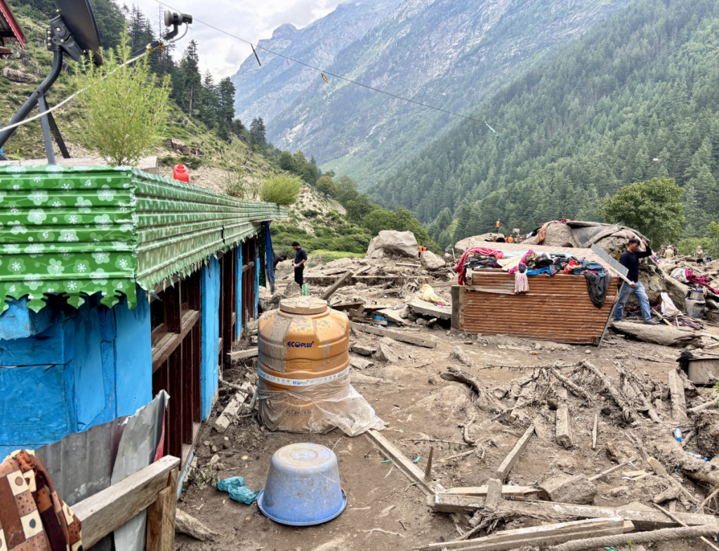 The remains of a residential house on the banks of Bhot whose base was eroded by the flash flood, burying the structure partially into the ground.