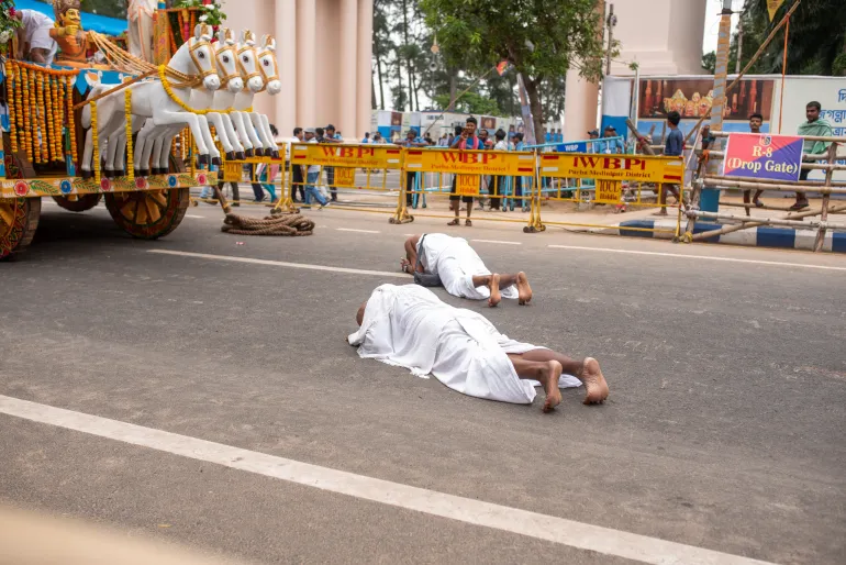 Two devotees praying in front of the chariot on the final day of Rath Yatra in Digha, West Bengal, on May 5, 2025