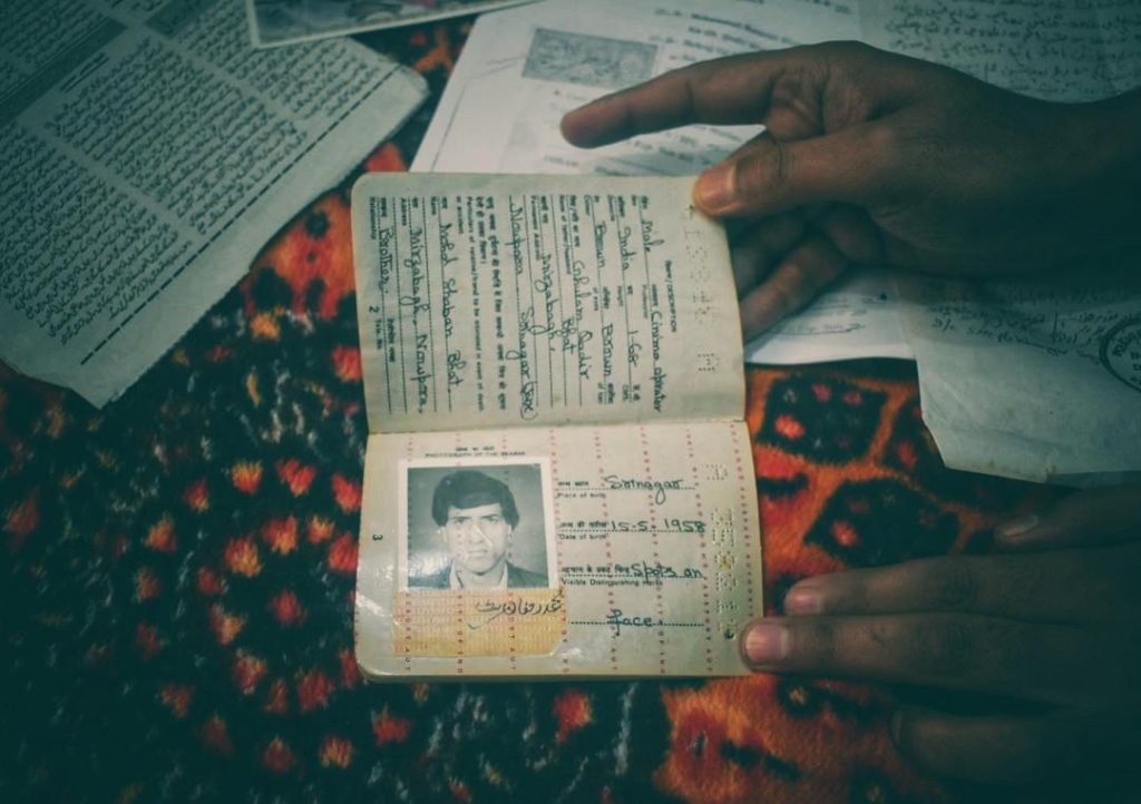 A family member showing the passport of Mohammad Ramzan Bhat, a shopkeeper who was detained and died in the custody of security forces in 1996.