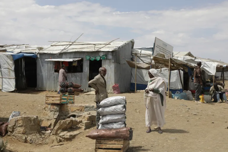 Internally displaced people walk through the Sebacare camp on the outskirts of Mekelle, Tigray region, Ethiopia, on February 12, 2025