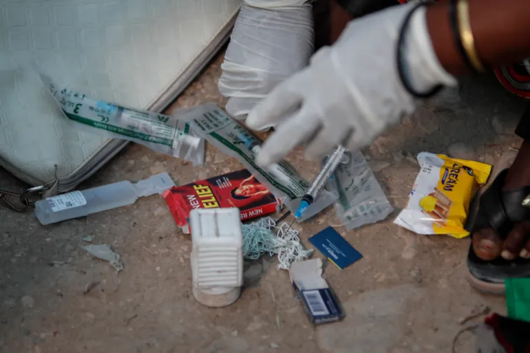 Safia Ibrahim shows the tools she uses to perform FGM, which she learned at the age of 15 and has been practising for 35 years, in the courtyard of her home in Hargeisa, Somaliland, a semi-autonomous breakaway region of Somalia, on February 7, 2022