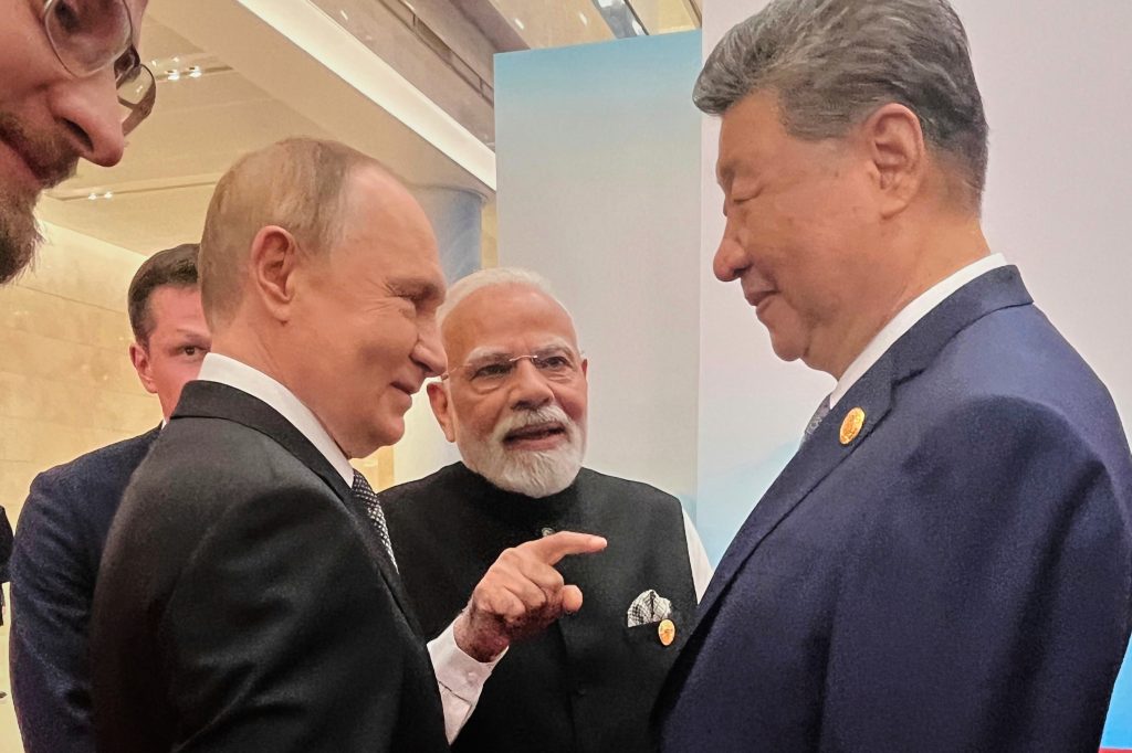 Russian President Vladimir Putin, Prime Minister Narendra Modi and Chinese President Xi Jinping talk ahead of the SCO summit in Tianjin, China.