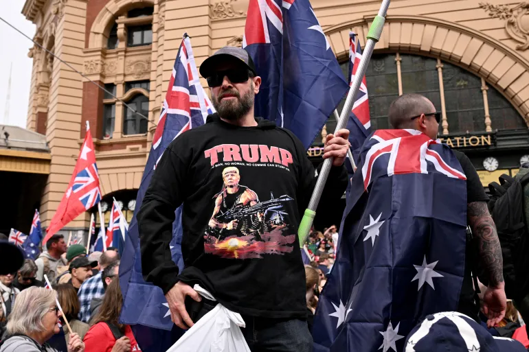 A protester wearing a shirt showing an image of US President Donald Trump as a stylised depiction of Rambo is seen during the “March for Australia” anti-immigration rally in Melbourne on August 31, 2025