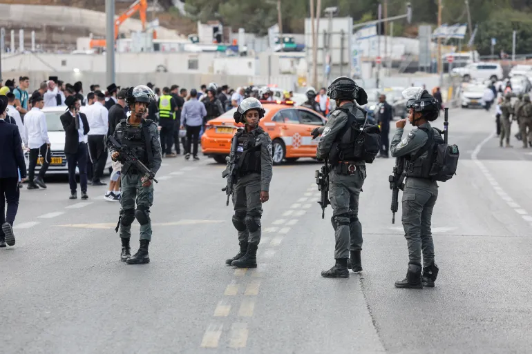Israeli police stand guard near the scene of a shooting attack at Ramot Junction in occupied East Jerusalem