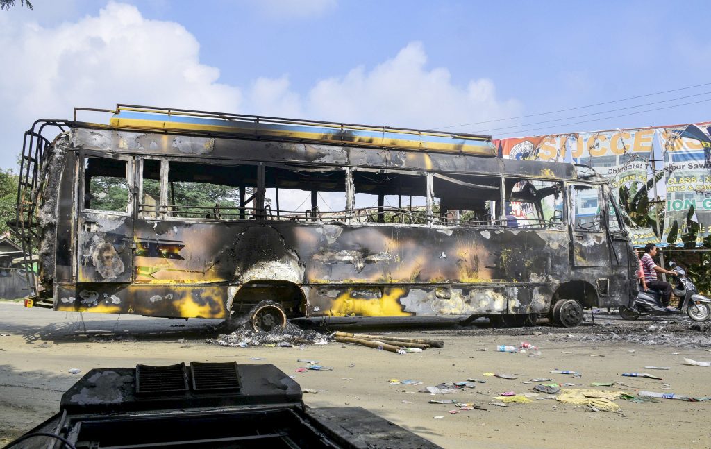 Charred remains of a bus used for transporting Union forces, which was set on fire by a mob, a day after protests erupted over Kanan’s arrest