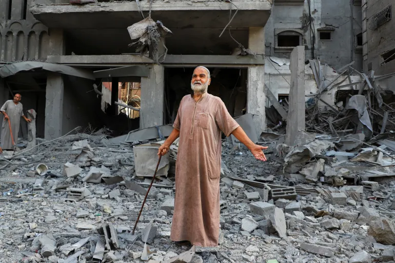 A Palestinian reacts as he inspects the site of Israeli strikes on houses at the Shati refugee camp, amid an Israeli military operation, in Gaza City, September 26, 2025