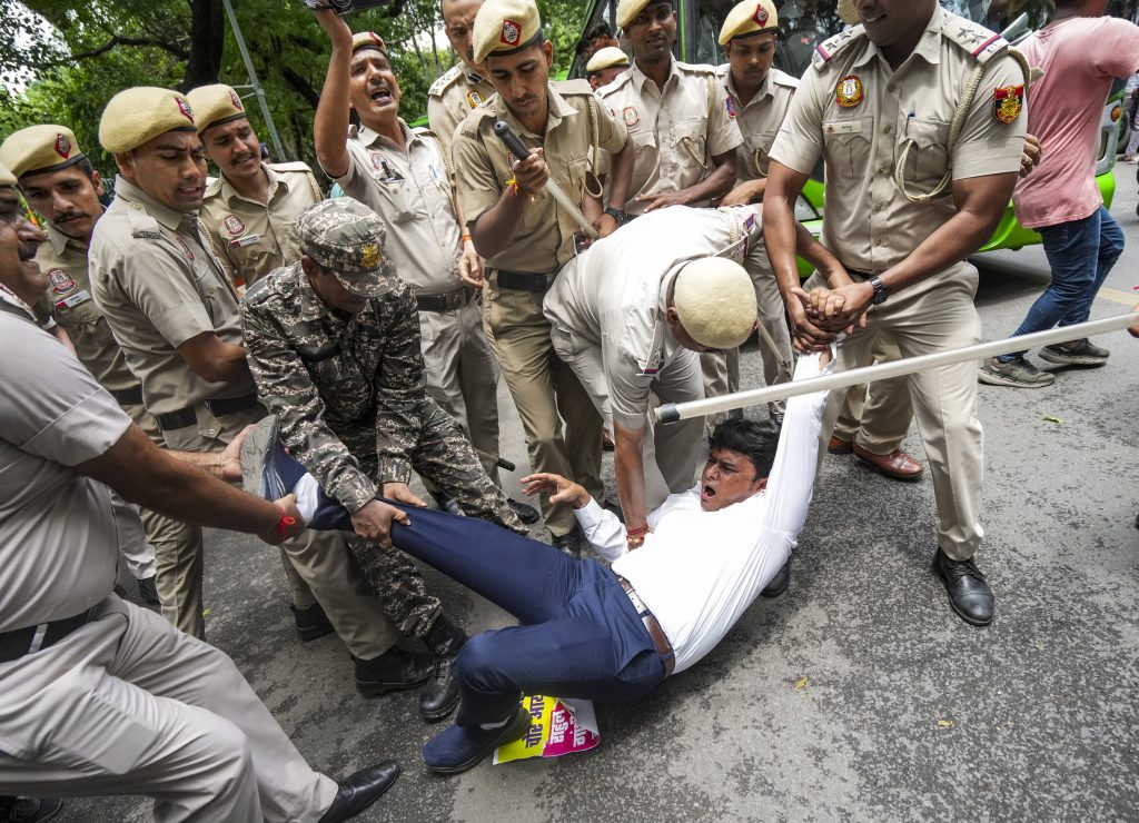 An agitator being detained during a protest by members of Indian Youth Congress over alleged ‘vote chori’ and Special Intensive Revision (SIR) of electoral rolls in New Delhi on August 12.
