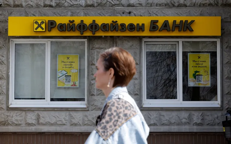 A pedestrian walks past a branch of Raiffeisen Bank in Moscow, Russia, on April 18, 2025
